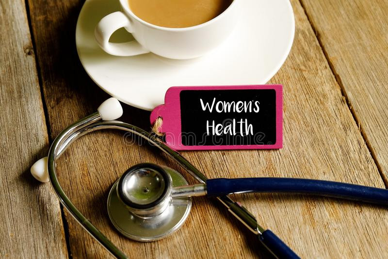 womenshealthmedicalconceptstethoscopecupcoffeewoodenboardwordswomenshealthwoodentable117846921.jpg