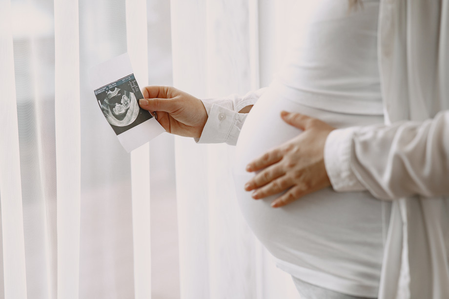 pregnantwomanstandingbywindowlookingphoto.jpg