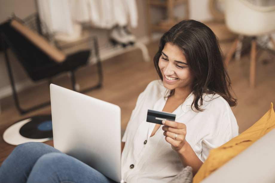 highanglesmilingwomanholdingcreditcard.jpg