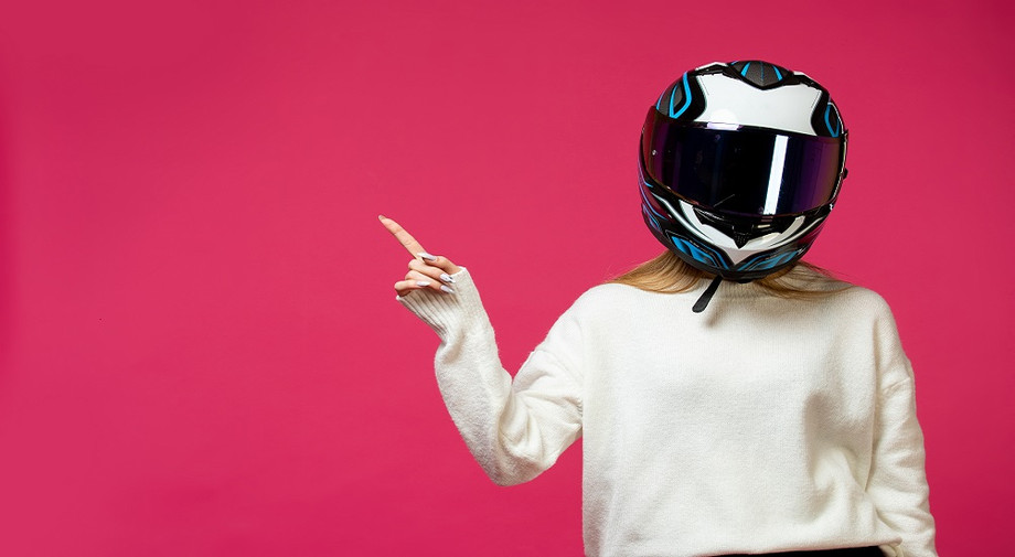 womanwhitepulloverwithmotorcyclehelmet.jpg