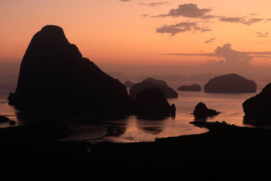 silhouetteofrockformationsonwaterphangngabayandamanseathailand.jpg