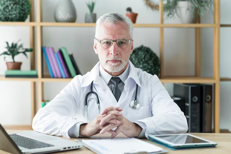 imgi_2_seniordoctorsittingoffice_232147896126.jpg