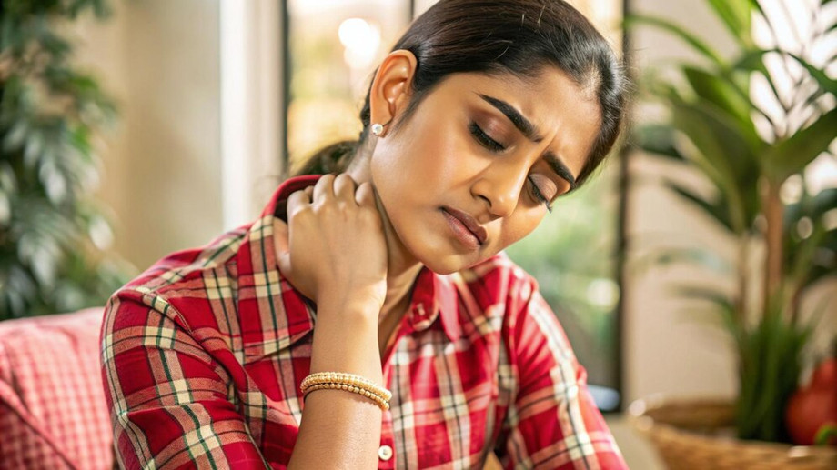 youngindianwomanwithfingersneckcheckeredshirtlookingpainfulfrontview_14610554764.jpg